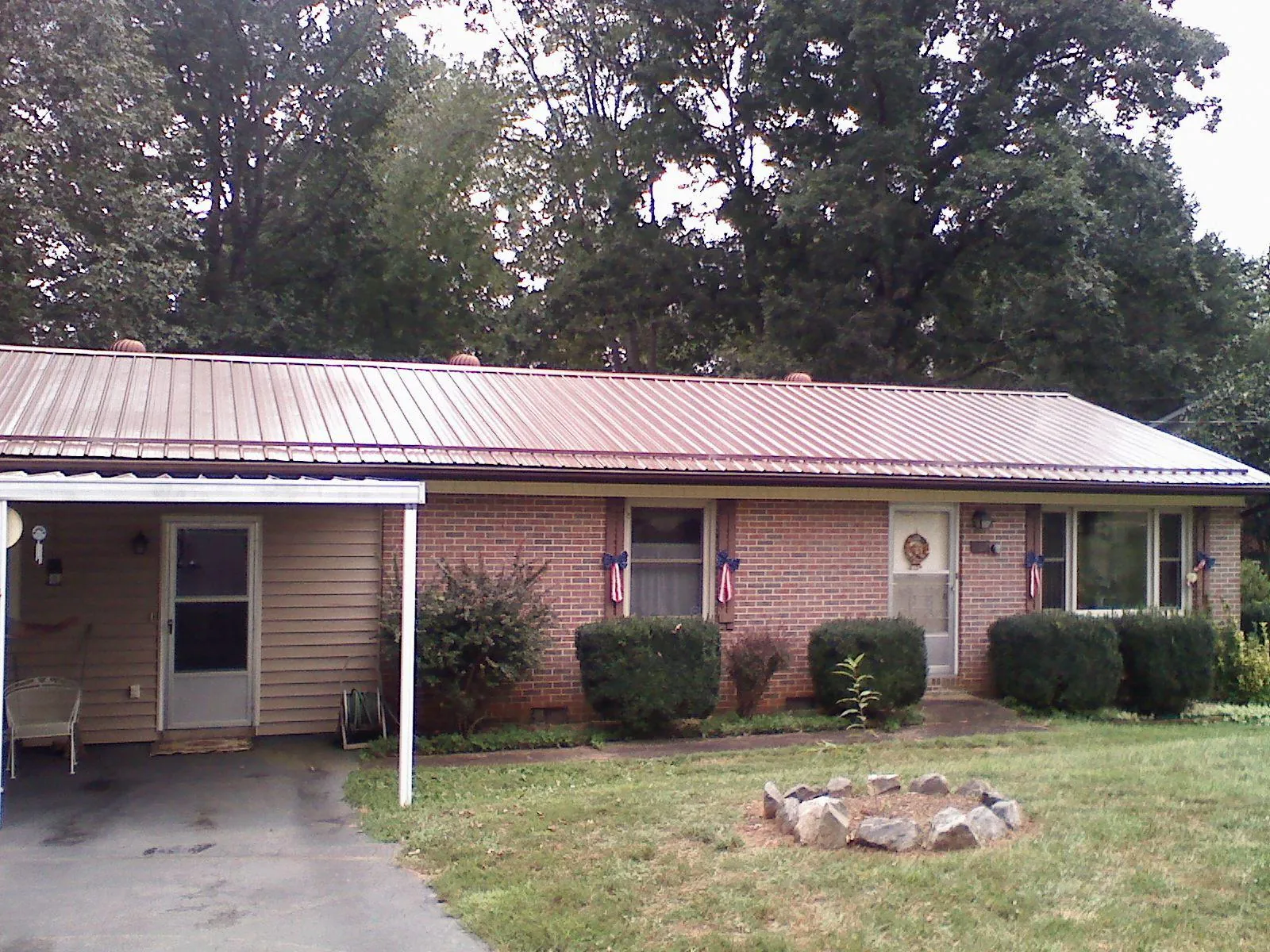 Bronze metal roof and carport on a brick ranch home — Roof Repair work by our crew in Little Ferry