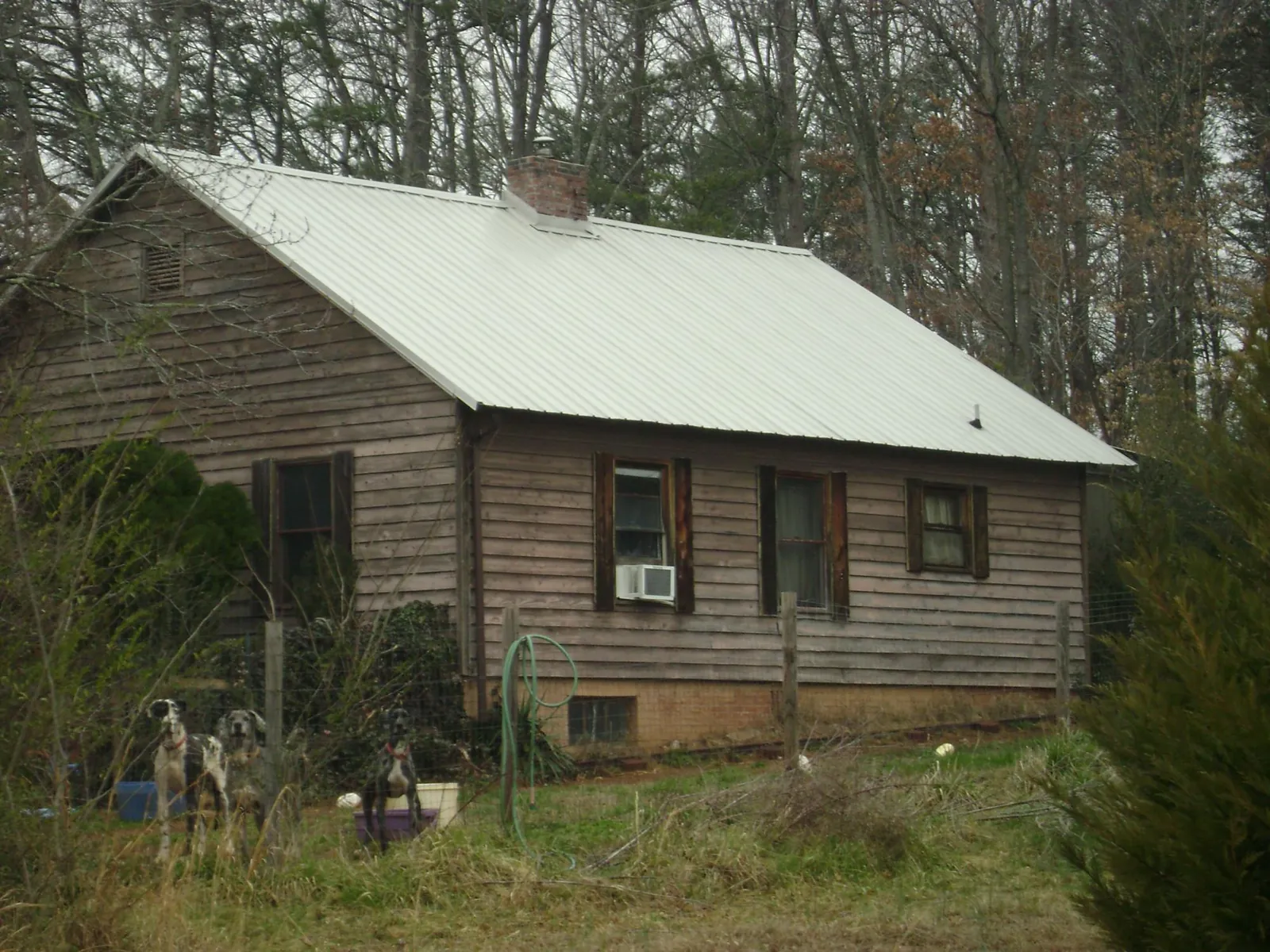 White metal roof on an old wood sided farmhouse, from a Asphalt Shingle Roof Repair job in Little Ferry